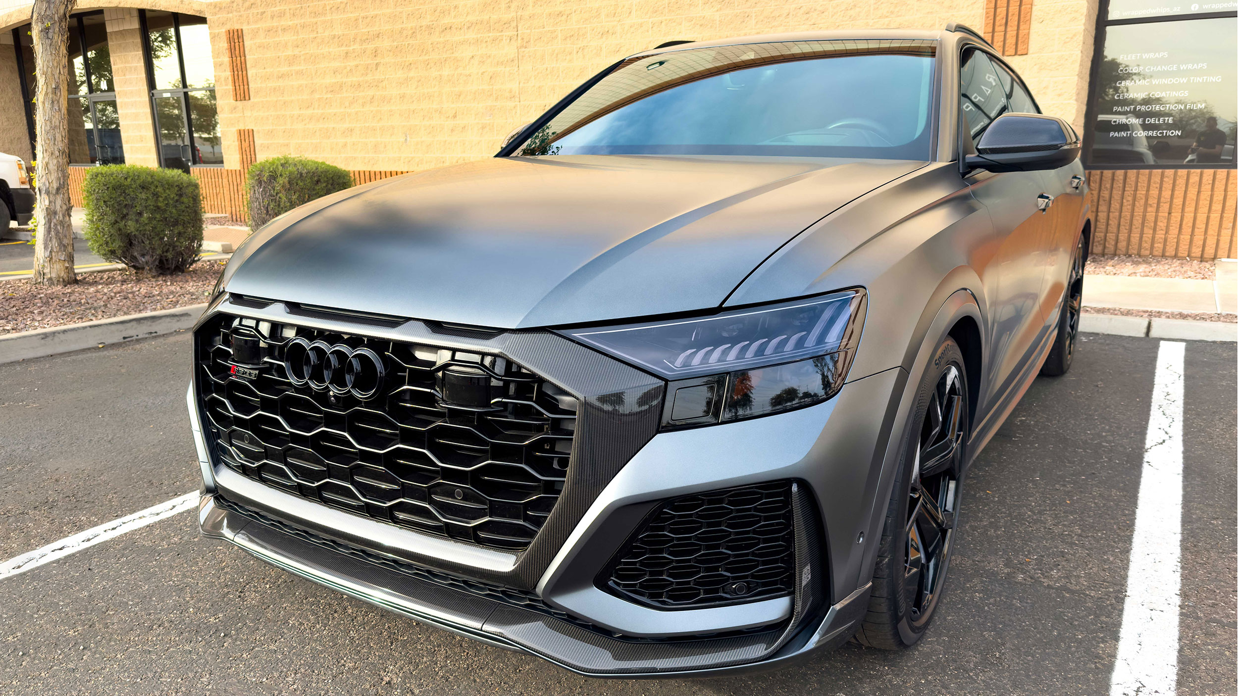 white porsche in a garage with windshield protection film